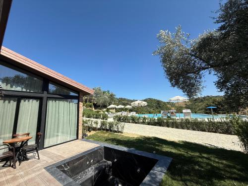 a patio with a table and chairs and a pool at Bujtina Ajazi in Golem