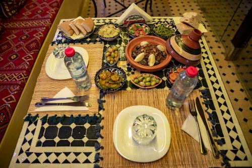 a table topped with plates of food on a table at Riad Shauala Fez in Fès