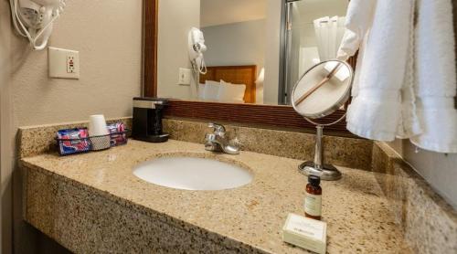 a bathroom counter with a sink and a mirror at Bally's Vicksburg in Vicksburg