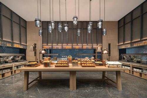 a kitchen with a table with food on it at Four Points by Sheraton Dalian Donggang in Dalian