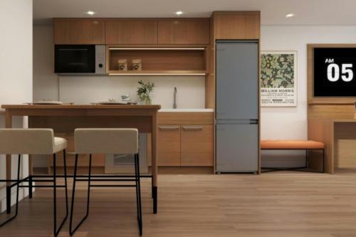 a kitchen with a table and chairs and a refrigerator at Element Seattle Downtown in Seattle