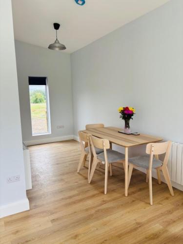 a dining room with a wooden table and chairs at Kildare Holiday Apartments No 1 in Kildare