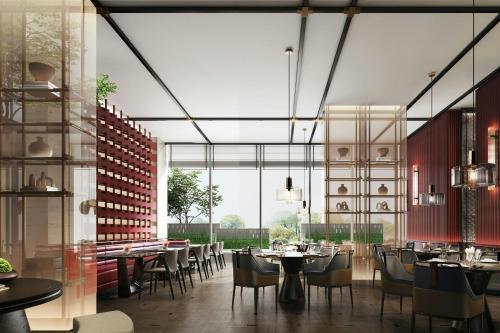 a restaurant with tables and chairs and a large window at Sheraton Kunshan Dianshan Lake in Kunshan