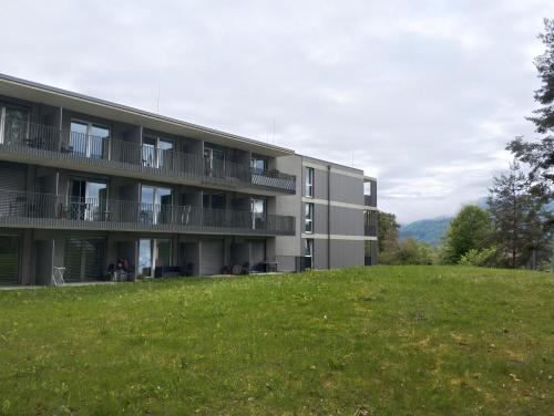 an apartment building with a green field in front of it at Stunning Wörthersee Holiday Home 15 in Sekull