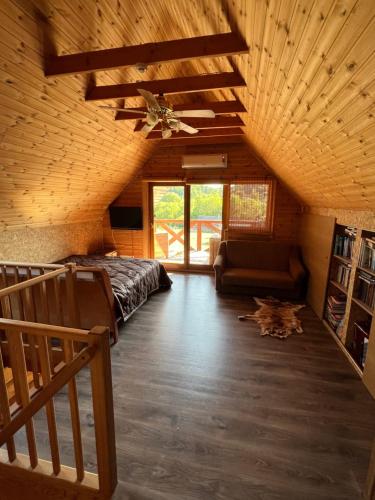 a bedroom with a bed and a ceiling fan at Visockyne in Ariogala