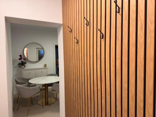 a sliding door in a room with a table at Serafina central Apartment in Satu Mare
