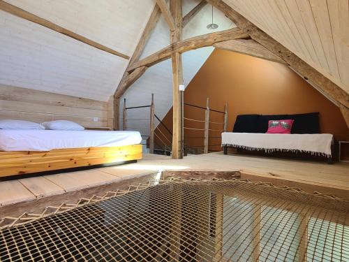 a bedroom with two beds in a attic at Gîte de l'Aiguille in Civray-de-Touraine
