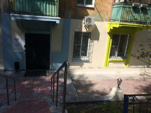 a building with stairs and a door and windows at Mini-Hotel Spi Zdes in Khabarovsk