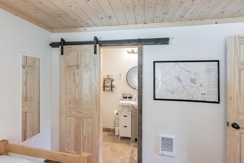 a room with a door and a map on the wall at Bungalow, Lake Glenville, Amazing Views, & Sauna! in Cullowhee