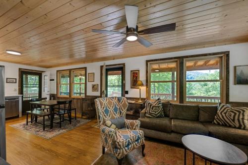 a living room with a couch and a ceiling fan at Bungalow, Lake Glenville, Amazing Views, & Sauna! in Cullowhee