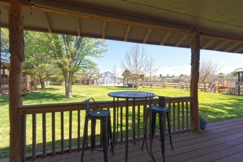 a porch with a table and two stools at Verde Valley Ranch Retreat - 4BR Guest House by Sedona & Jerome in Cottonwood