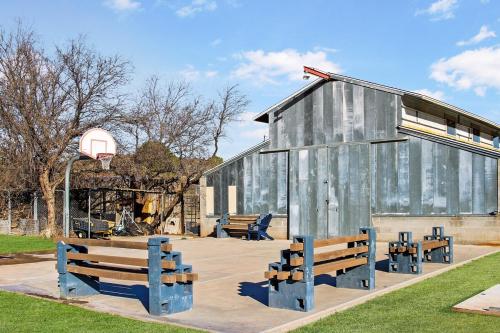 a group of benches in front of a building at Verde Valley Ranch Retreat - 4BR Guest House by Sedona & Jerome in Cottonwood