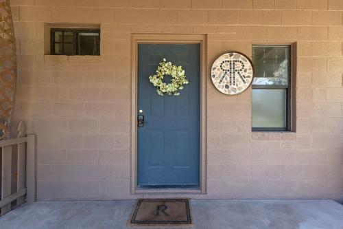 a blue door with a wreath and a clock on a building at Verde Valley Ranch Retreat - 4BR Guest House by Sedona & Jerome in Cottonwood
