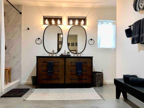 a bathroom with a wooden dresser with two mirrors at Verde Valley Ranch Retreat - 4BR Guest House by Sedona & Jerome in Cottonwood