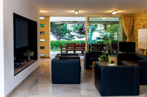 a living room with couches and a tv at Illustrious Brac Villa 6 Bedrooms Villa Bol Waterfront Private Pool & Balcony With Beautiful Views Bol in Bol