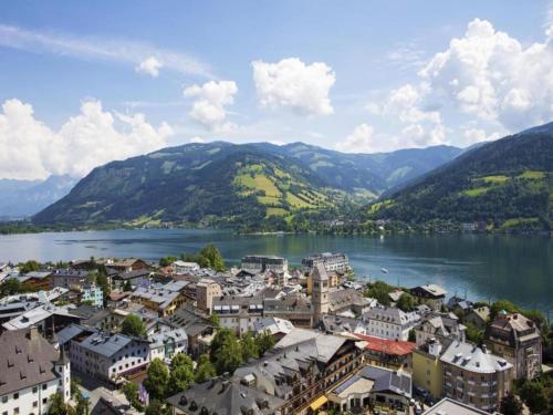 a town on the shore of a lake with mountains at Jünkerath Romantic Garden Stay in Jünkerath