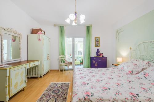 a bedroom with a bed and a dresser and a refrigerator at Apartment Bella Rosa in Koper