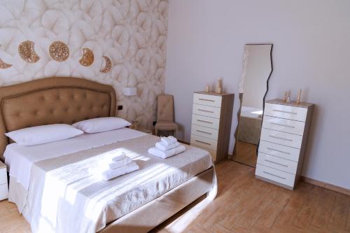a bedroom with a bed with two towels on it at Etherea Guest House in SantʼAntonio Abate