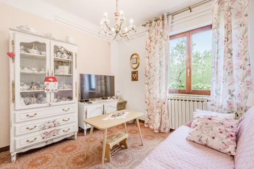 a living room with a white cabinet and a tv at Apartment Bella Rosa in Koper