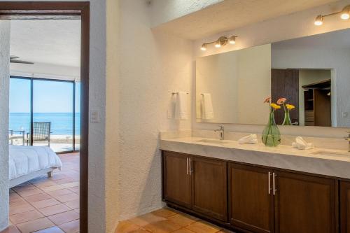a bathroom with a sink and a large mirror at Villa Costa Azul by Cabo Villas in San José del Cabo