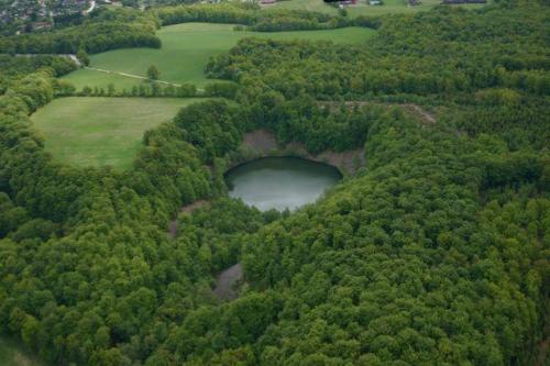 an aerial view of a golf course with a lake at Nature Park View in Röstånga