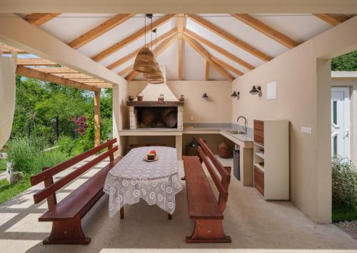 an outdoor kitchen with a table and a stove at House Madrino in Kreševo