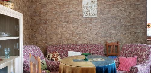 a living room with a table and a couch at Casa Marta in Setenil