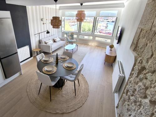 a living room with a table and chairs and a couch at Muros sobre el puerto in Muros