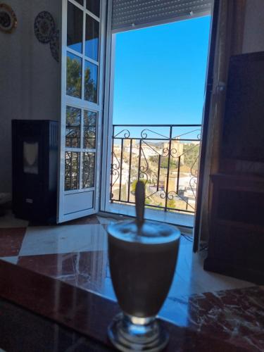 a candle sitting on a table in front of a door at Casa Marta in Setenil