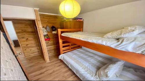 a bedroom with two bunk beds and a lamp at Cabana Horcon in Horcón