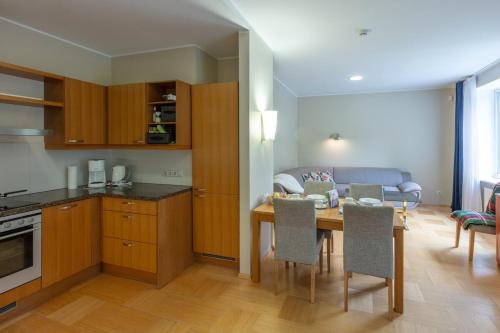 a kitchen and dining room with a table and chairs at Private Entry Apt Pärnu in Pärnu