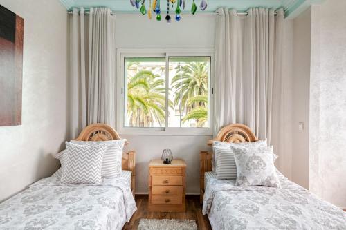 a bedroom with two beds and a window at Apartment with sea view in Mohammedia