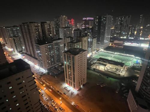 a view of a city at night with buildings at AlNahda Border SHJ-DXB- 2BADROOM AND HALL FULL FLAT FOR YOU ONLY in Sharjah