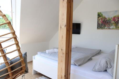 a bedroom with a ladder next to a bunk bed at Penzion-apartmán Souček in Jindrichuv Hradec
