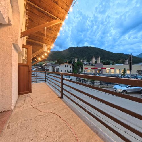 a balcony with a fence and a view of a city at Shara Hotel in Mestia