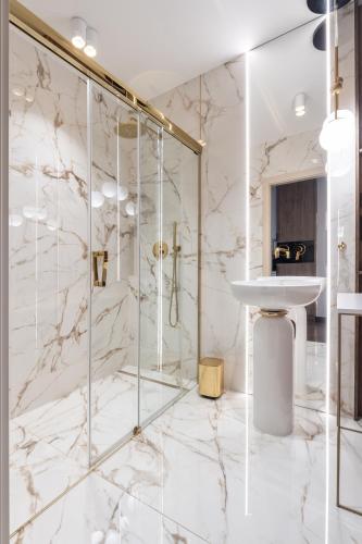 a bathroom with a shower and a sink at SAUNA JACUZZI River View QUORUM Apartment in Wrocław