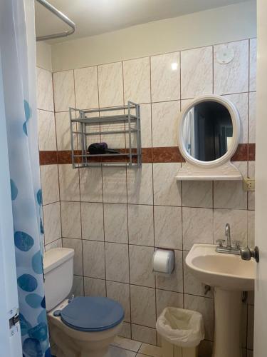 a bathroom with a toilet and a sink and a mirror at Miraflores Moonlight in Lima