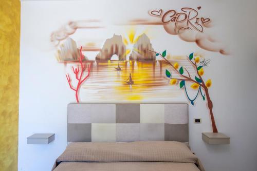 a bedroom with a painting on the wall at B&B Casanova in Agerola