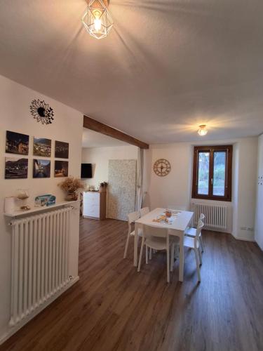 a dining room with a white table and chairs at Casa Jedi in Santa Maria Maggiore