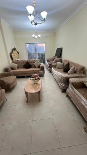 a large living room with couches and a table at AlNahda Border SHJ-DXB -ZAMAZM GuestHouse in Sharjah