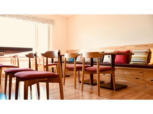 a dining room with chairs and a table with a counter at Hotel Hanafuji Inn - Vacation STAY 60989v in Nakafurano