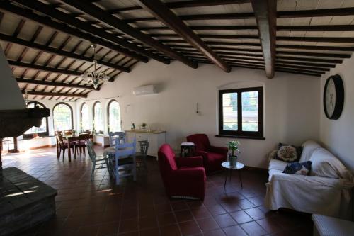 a living room with red chairs and a table at Areté rooms in Cupra Marittima