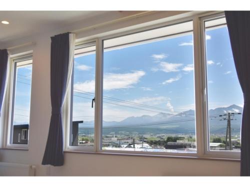 a window with a view of the mountains at Hotel Hanafuji Inn - Vacation STAY 61010v in Nakafurano