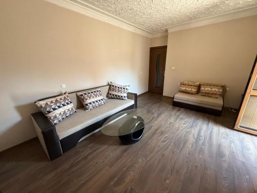 a room with a bed and a couch and a table at Central apartments Pleven in Pleven