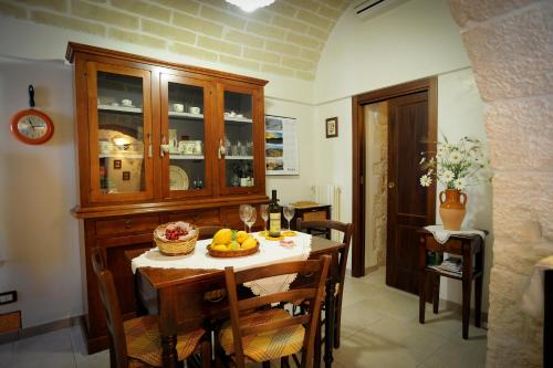 a kitchen with a table with a bowl of fruit on it at Trullo Di Tagaro in Locorotondo