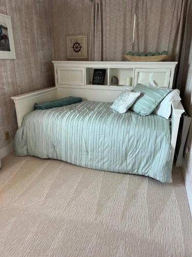 a bed with two pillows on it in a bedroom at Almost Eden Guesthouse in Carmel