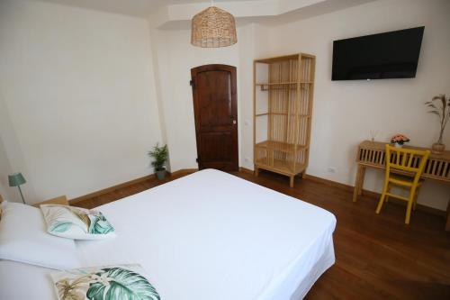 a living room with two beds and a television at Areté rooms in Cupra Marittima