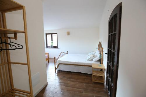 a bedroom with a bed and a wooden floor at Areté rooms in Cupra Marittima