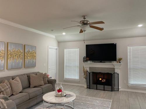 a living room with a couch and a fire place at Central NWA-Games, Concerts, Nature and More in Lowell