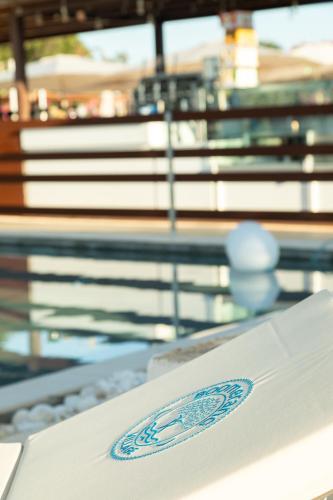 a white table with a logo on top of it at Boomerang Village in Torre Colimena
